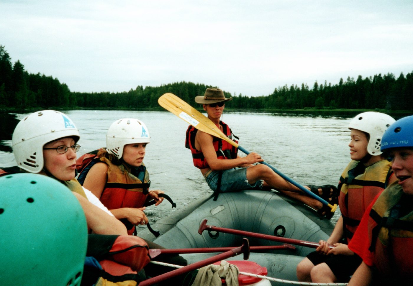 Rafting group on the river with the guide steering