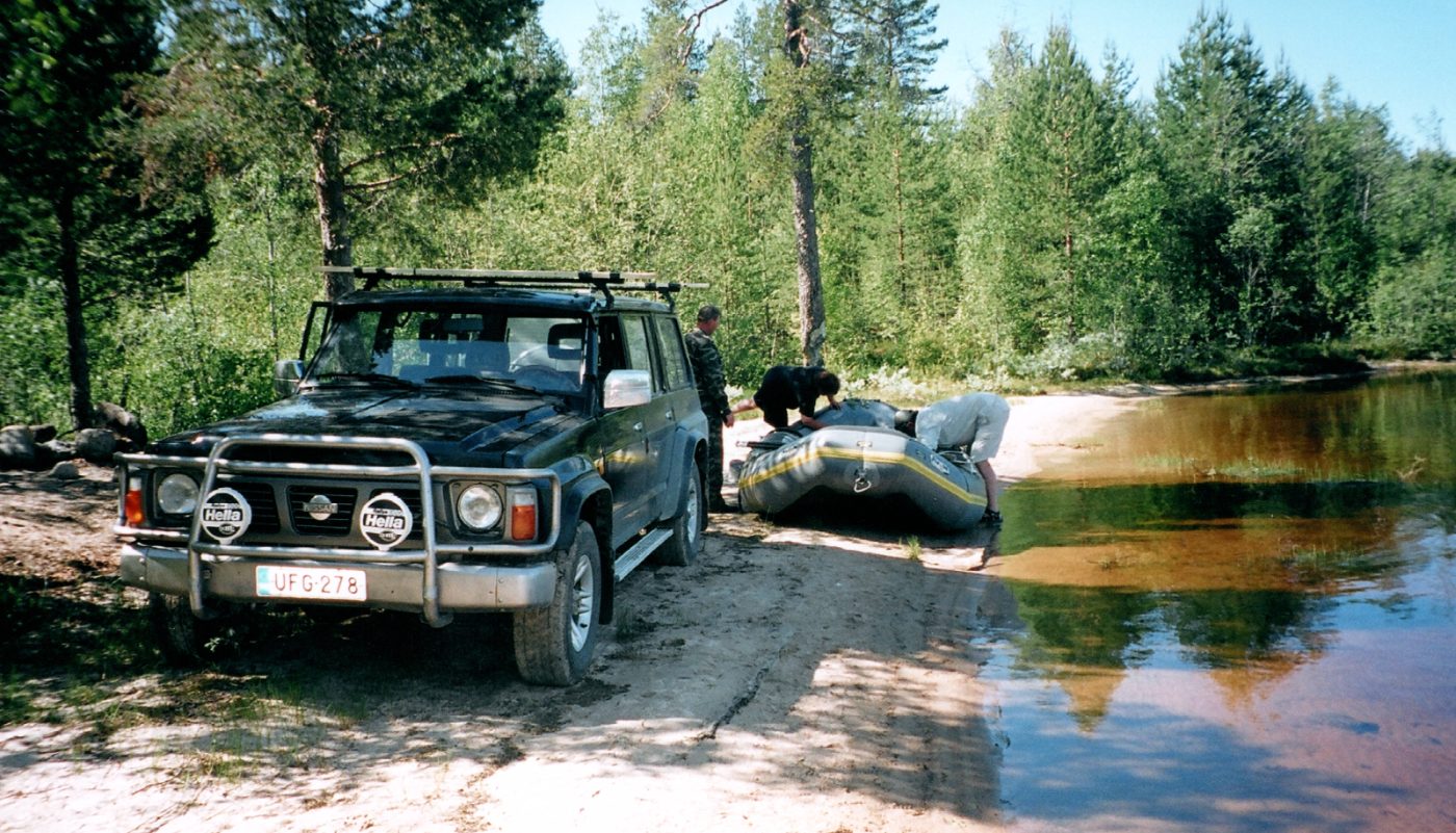 Crew preparing the raft at the riverbank before launch