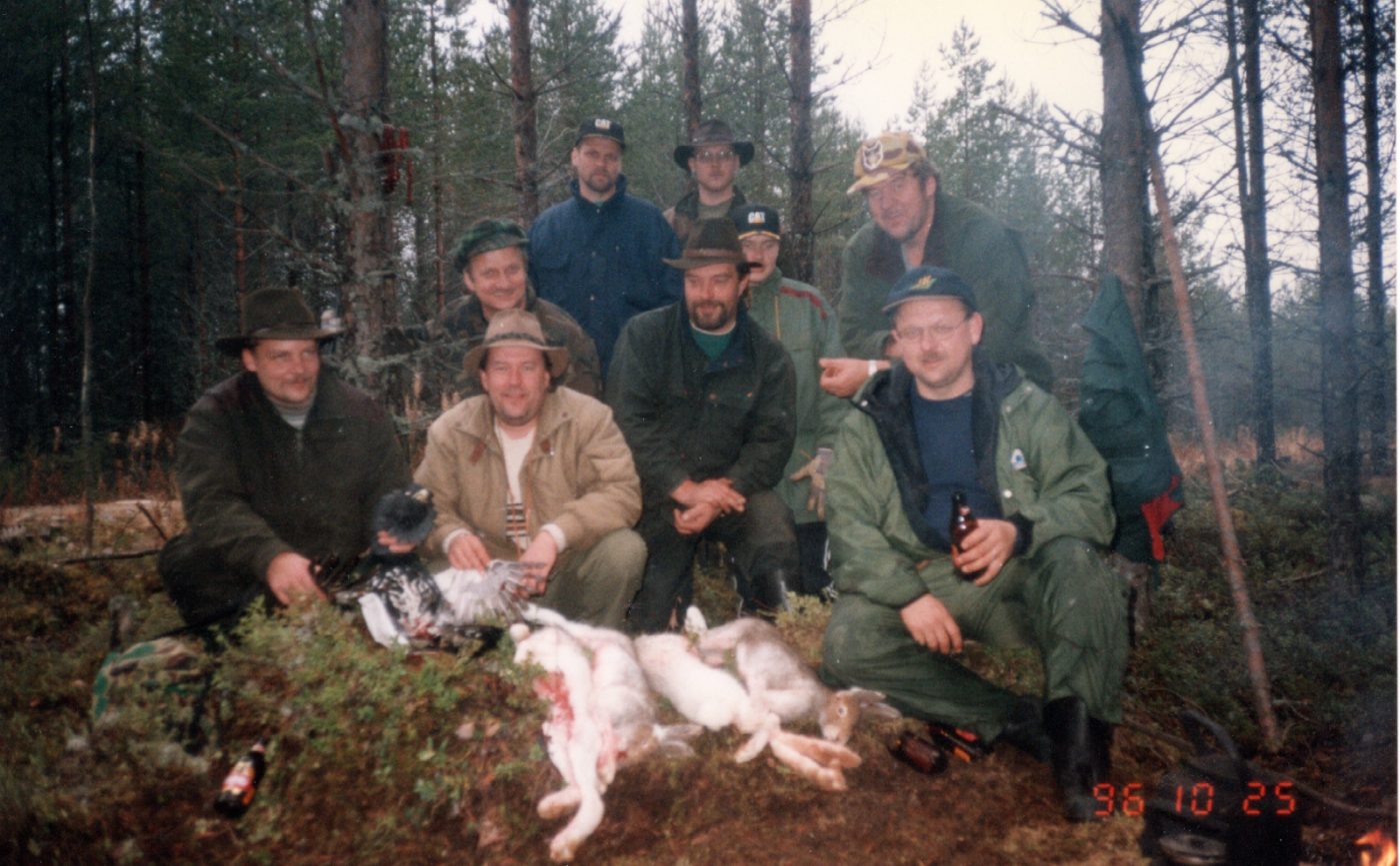 Hunting party with the game of the day by the campfire, Lieksa, October 1996